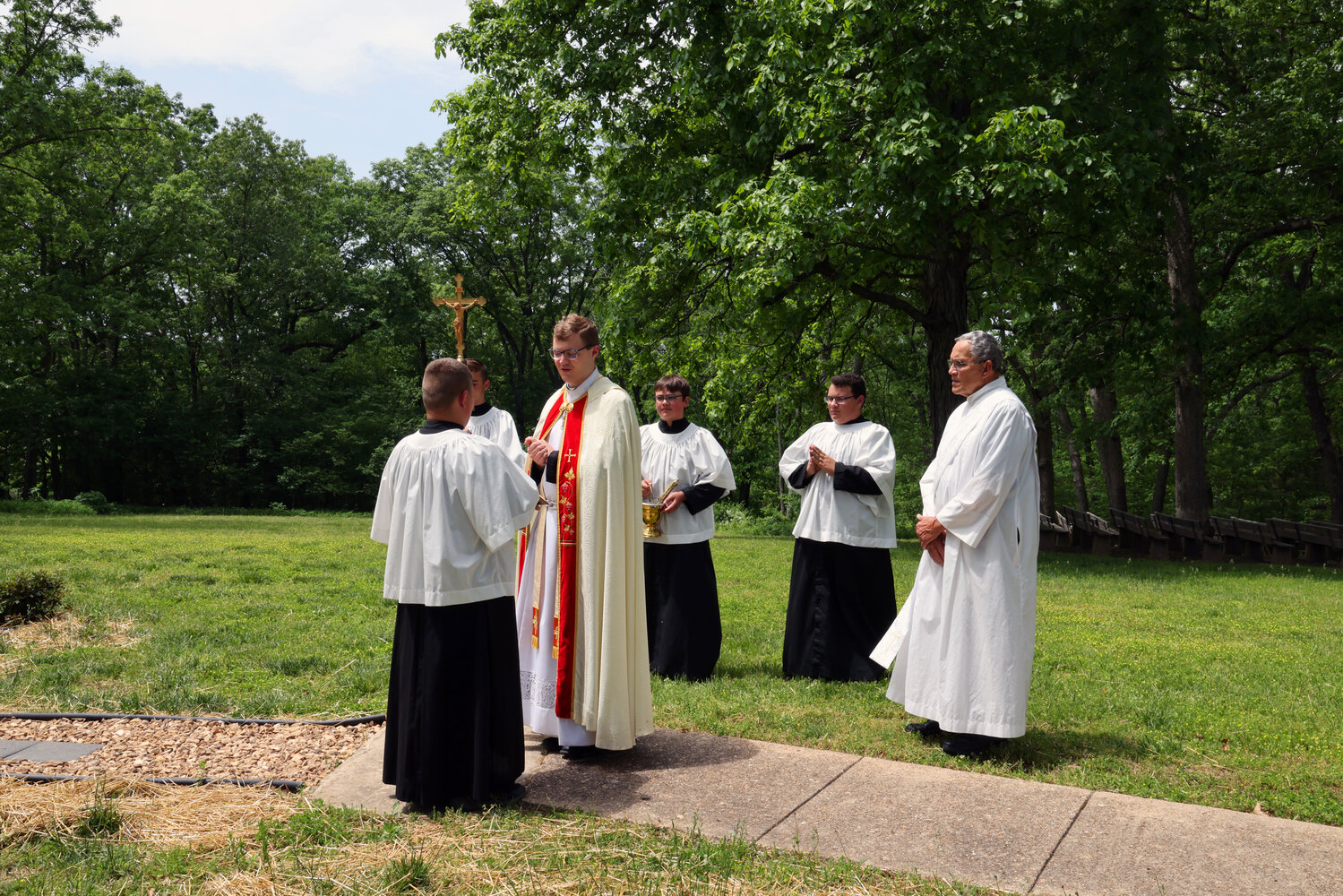 Father Tony Ritter of the St. Louis archdiocese, Sam Cramer’s Eagle Scout mentor, blesses and dedicates the Rosary Walk Sam built for an Eagle Scout project outside the chapel of the Shrine of Our Lady of Sorrows in Starkenburg, on May 13, the Feast of Our Lady of Fatima.